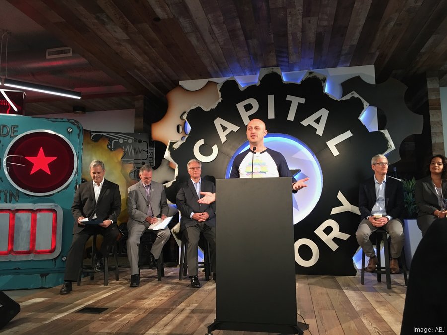 On the Capital Factory stage in front of the gear logo &mdash; one of countless events he hosted.